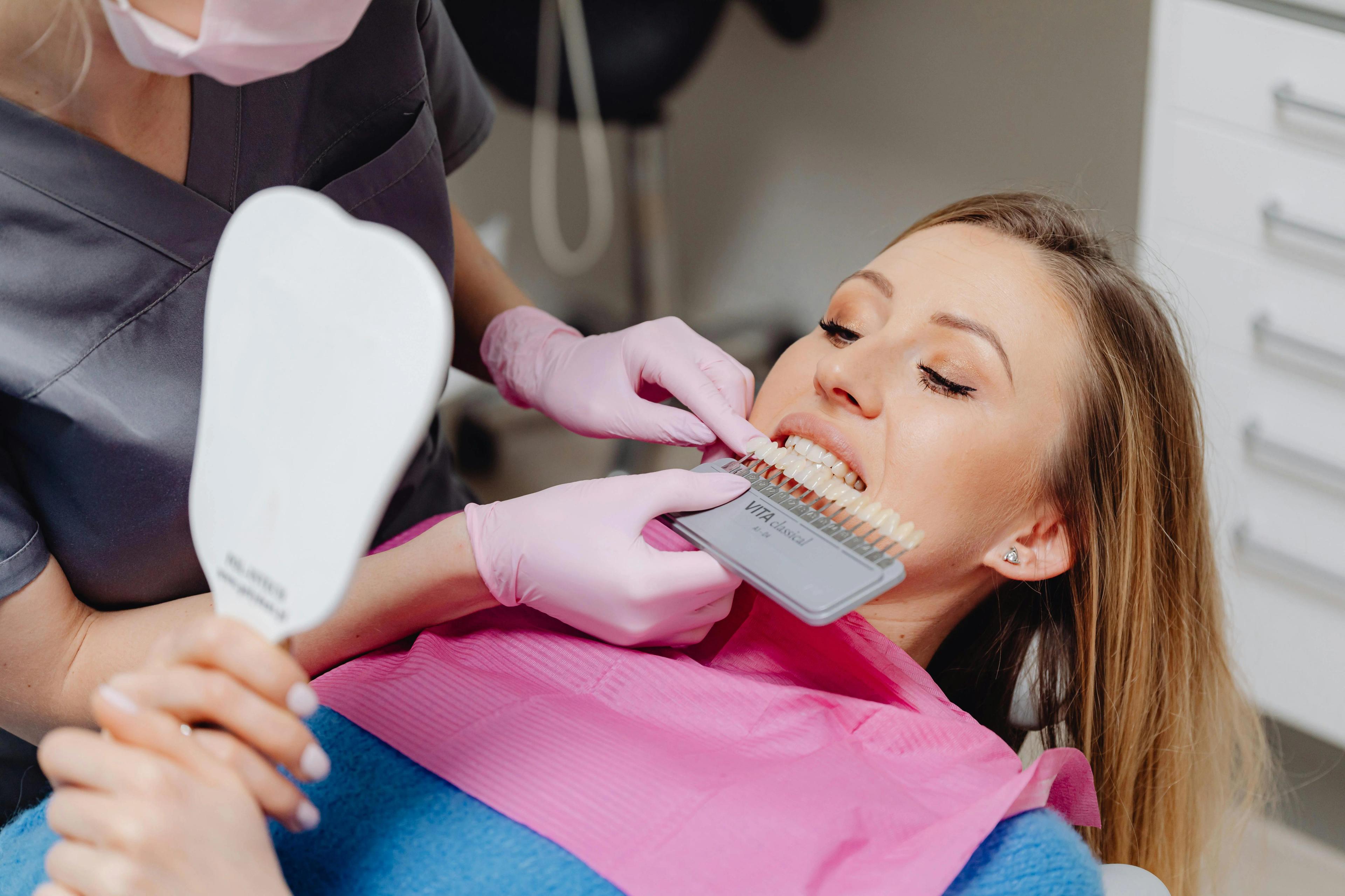 Dentist checking patients teeth shade