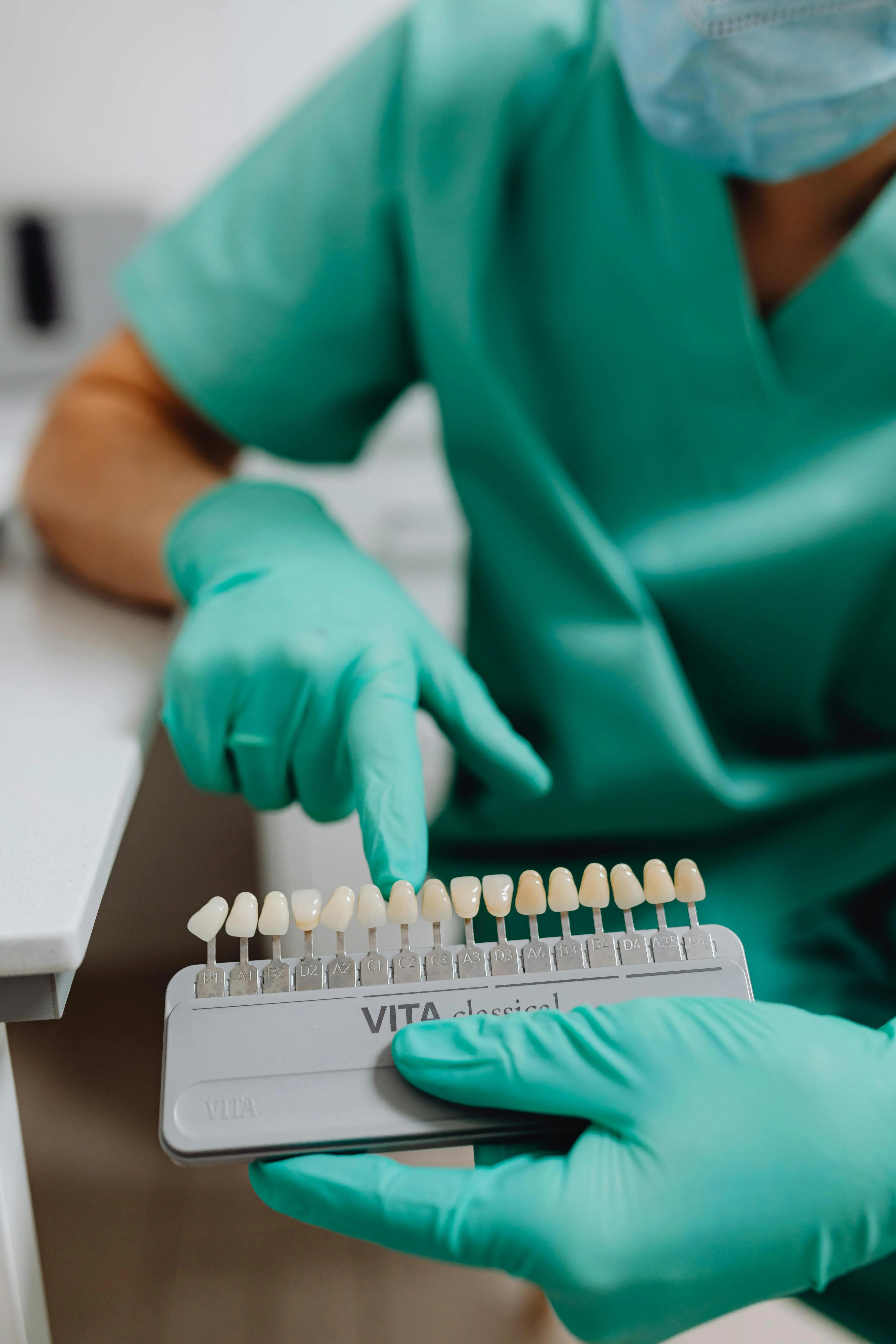 Dentist showing teeth whitening shades